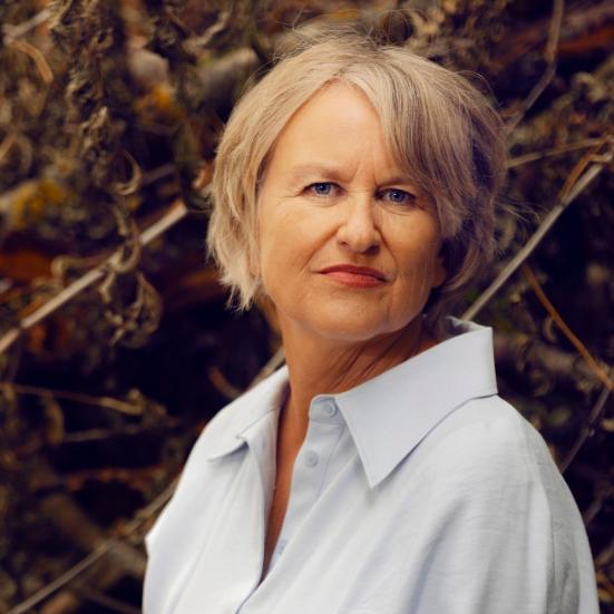 Forfatterporstræ af Ida Jessen foran nogle grene efterårsfarver